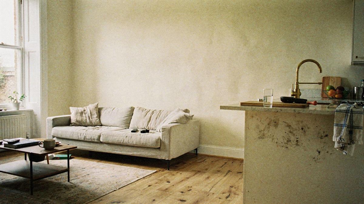 Completed living room and kitchen of a renovated Kyiv apartment with lime plaster walls and oak flooring